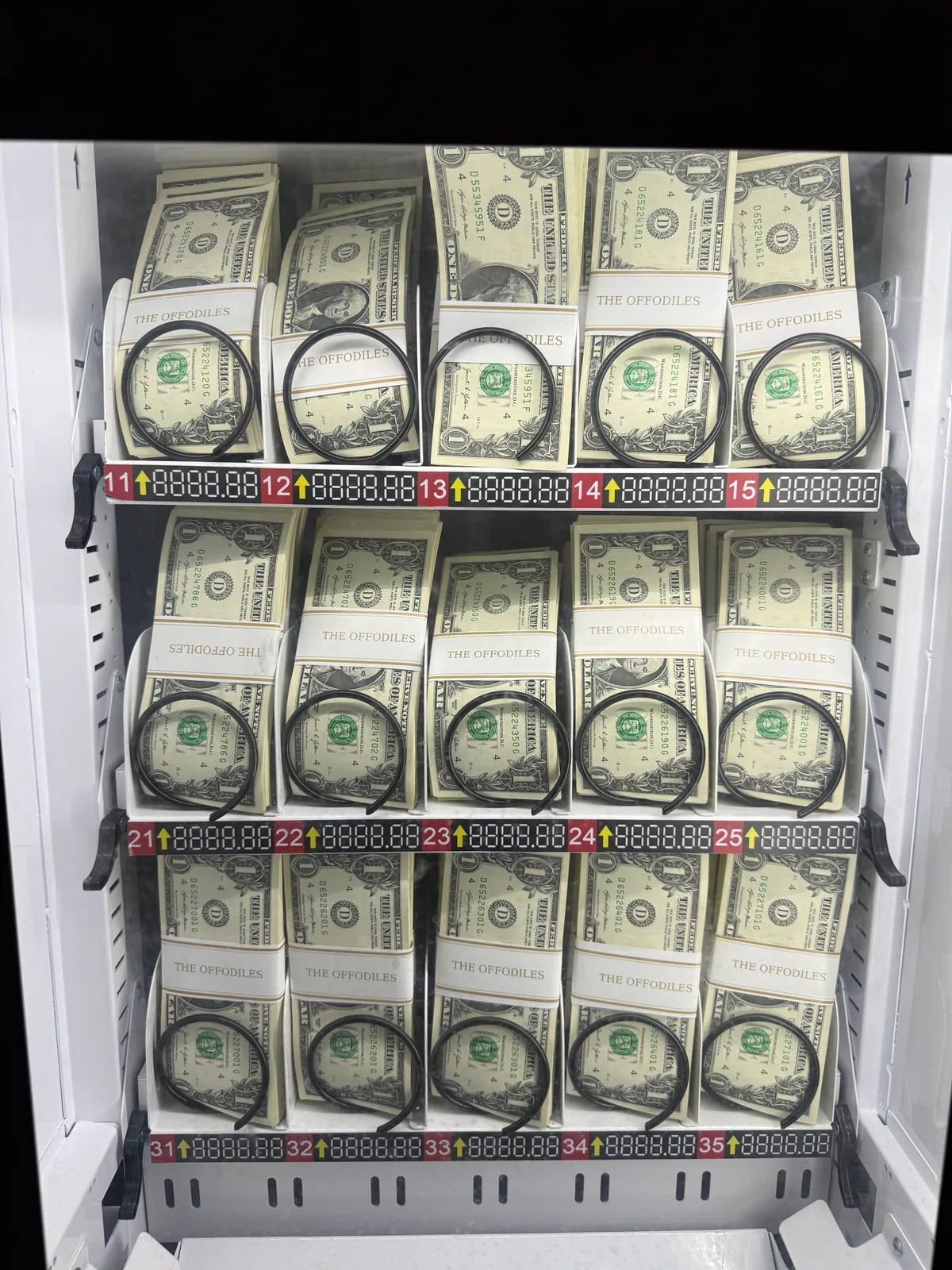 US $1 bills in bundles with personalized paper bands inside the cash station